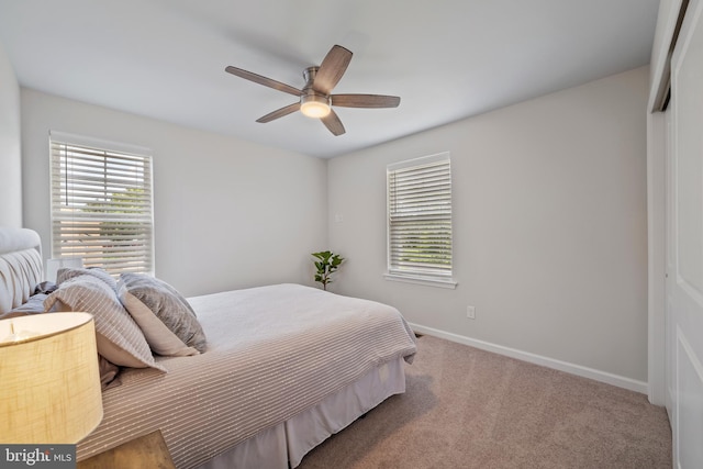 carpeted bedroom with a closet and ceiling fan