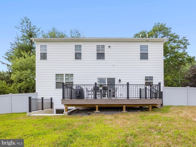 back of house featuring a yard and a deck