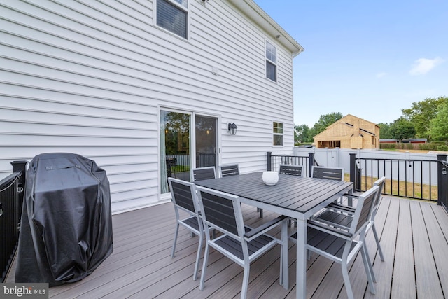 wooden deck with a grill