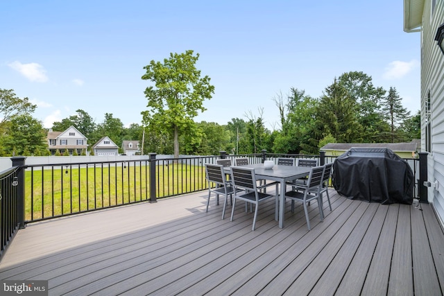 deck with grilling area and a yard