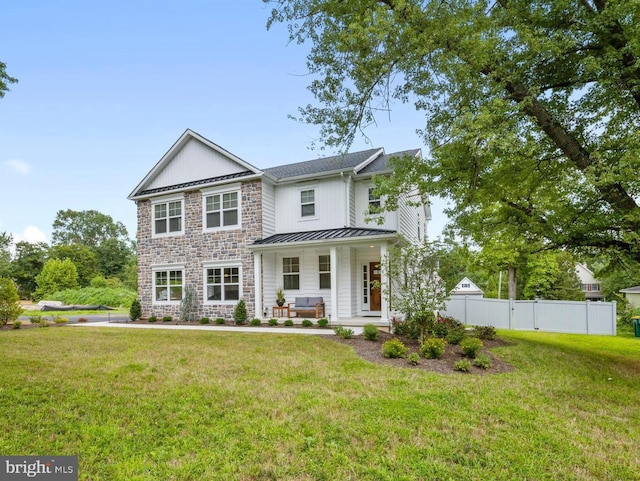 view of front of home with covered porch and a front lawn