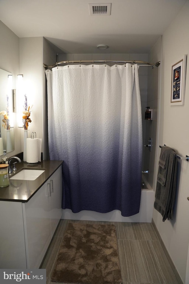 bathroom featuring vanity and shower / bath combo with shower curtain