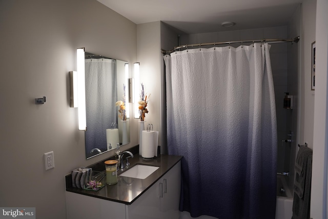 bathroom with shower / bath combo with shower curtain and vanity