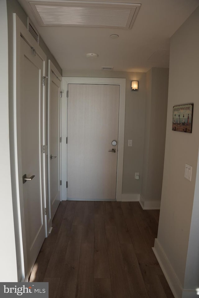 hall with dark hardwood / wood-style floors