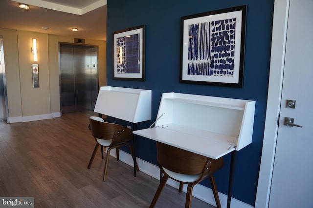 home office with dark wood-type flooring and elevator