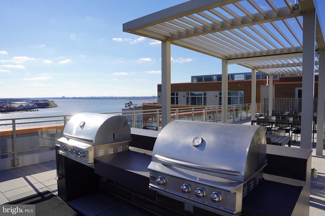 view of patio / terrace with a pergola, a water view, and a grill