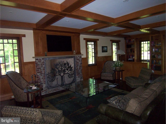 living room with a fireplace, beam ceiling, wooden walls, and coffered ceiling