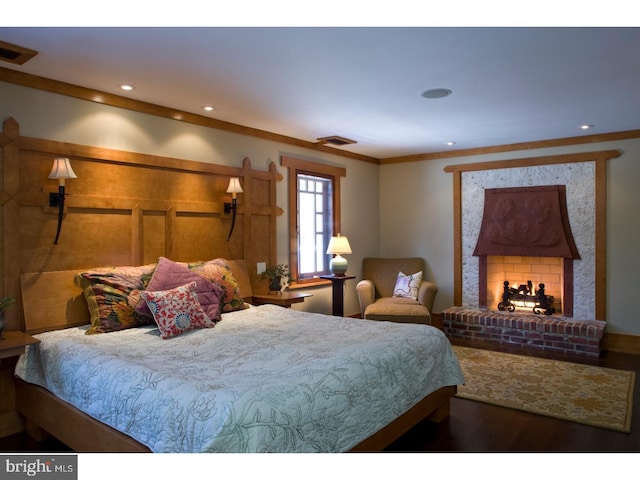 bedroom with ornamental molding and hardwood / wood-style flooring