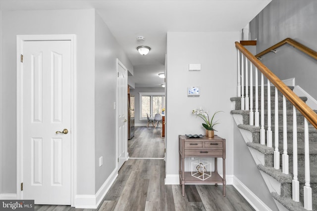 hallway with hardwood / wood-style flooring