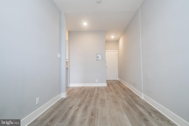 corridor with light hardwood / wood-style flooring