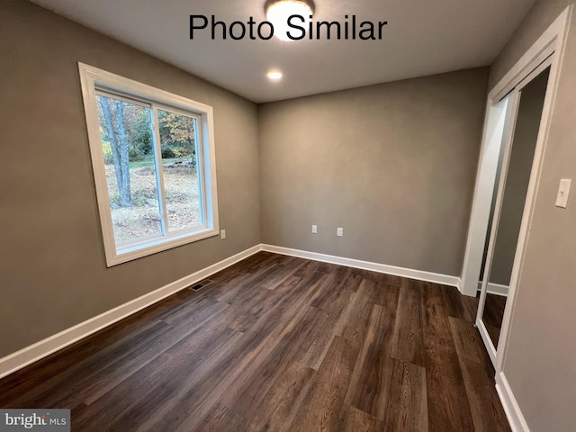 spare room featuring dark hardwood / wood-style floors