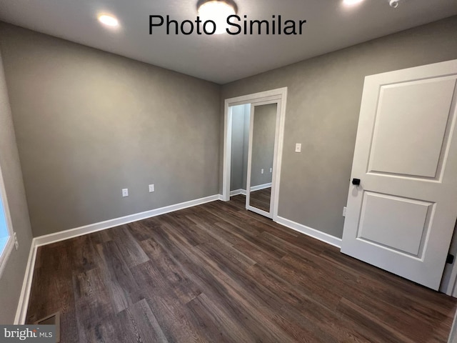 unfurnished bedroom with dark hardwood / wood-style floors