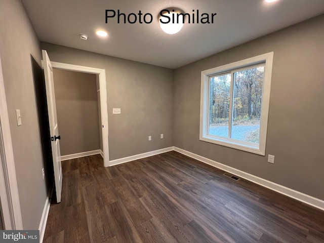 spare room featuring dark hardwood / wood-style floors