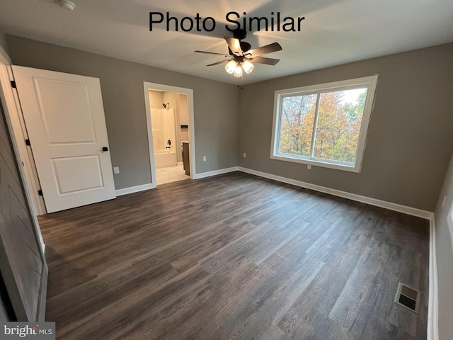 unfurnished bedroom with ensuite bathroom, dark hardwood / wood-style flooring, and ceiling fan