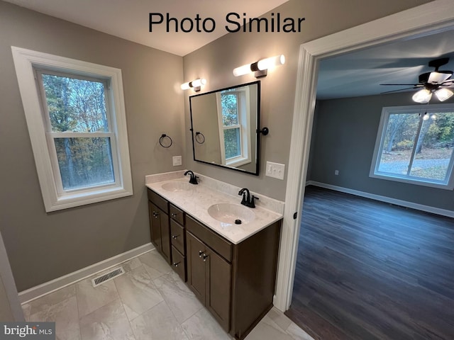 bathroom featuring vanity, a healthy amount of sunlight, and ceiling fan