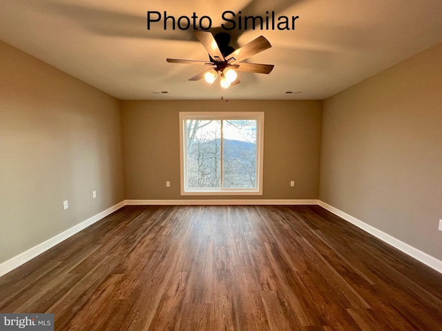 spare room with ceiling fan and dark wood-type flooring