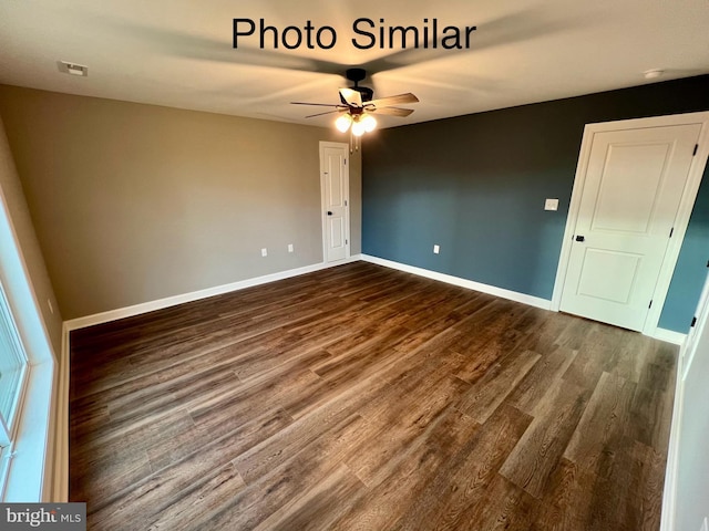 unfurnished room featuring ceiling fan and dark wood-type flooring