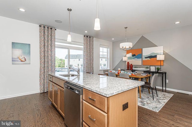 kitchen with dishwasher, sink, hanging light fixtures, dark hardwood / wood-style flooring, and a center island with sink