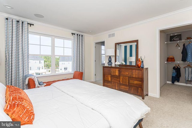 bedroom featuring carpet flooring, crown molding, and a closet