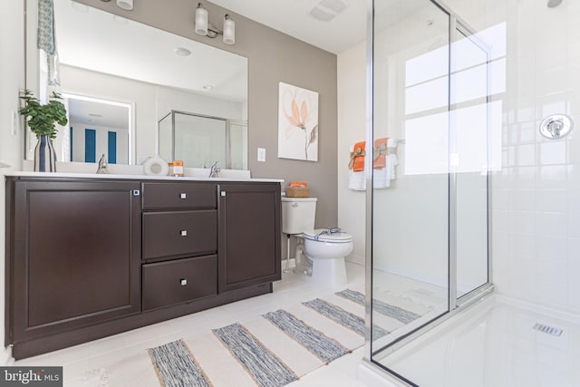 bathroom with tile patterned flooring, vanity, toilet, and walk in shower