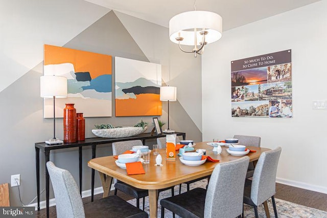 dining area featuring wood-type flooring and a notable chandelier