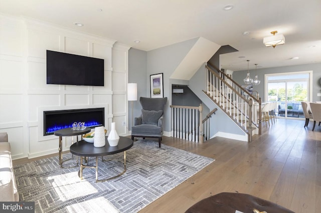 living room featuring dark hardwood / wood-style floors and an inviting chandelier