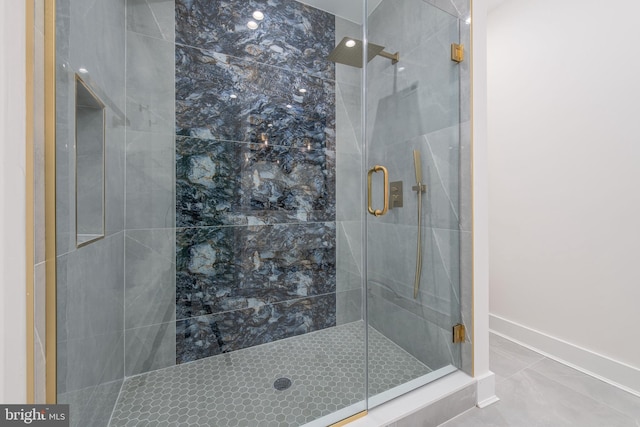 bathroom featuring tile patterned flooring and a shower with shower door