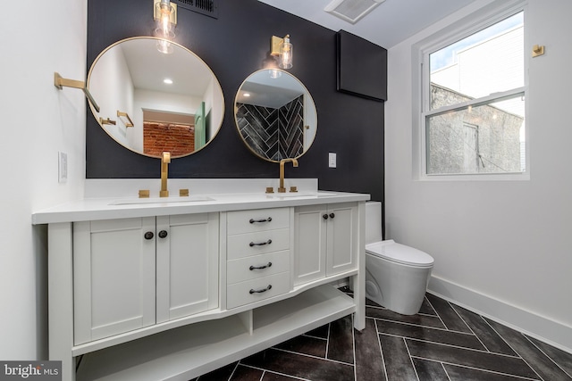 bathroom with tile patterned flooring, vanity, and toilet