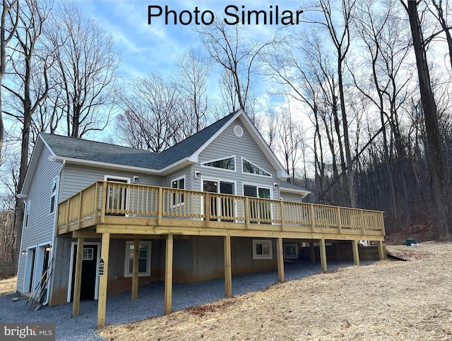 back of house with a deck and a garage