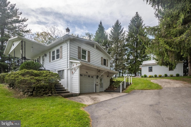 view of side of home featuring a garage and a lawn