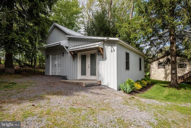 exterior space featuring french doors and a front lawn