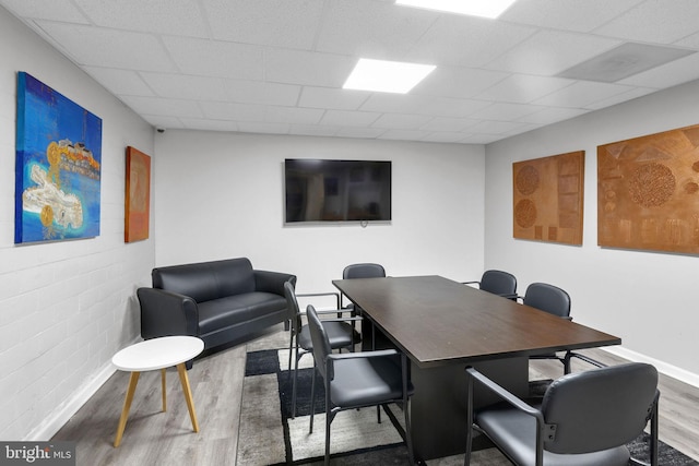 office area with wood-type flooring and a drop ceiling