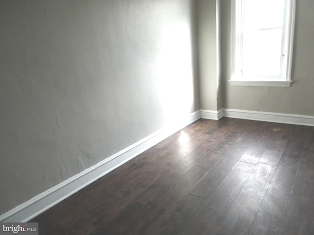 spare room featuring dark hardwood / wood-style floors