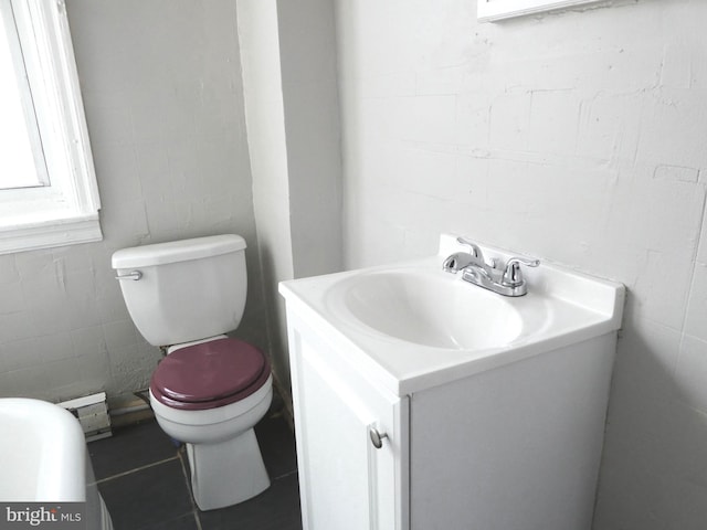 bathroom featuring tile patterned floors, vanity, and toilet