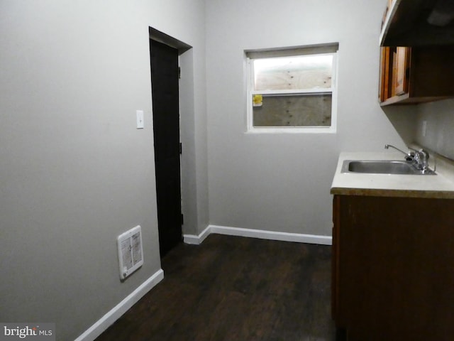 interior space with sink and dark wood-type flooring