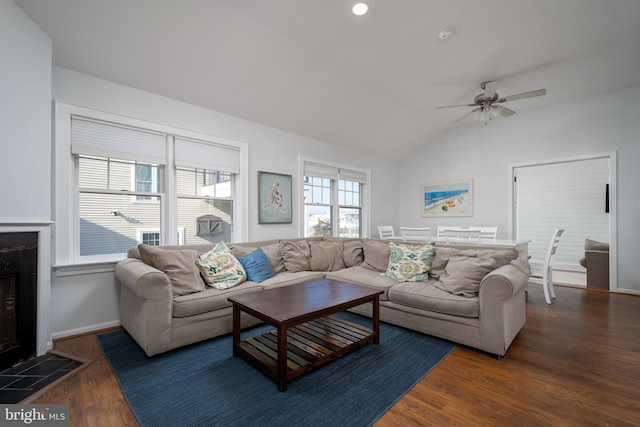 living room featuring lofted ceiling, ceiling fan, and dark wood-type flooring