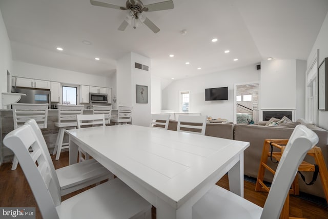 dining area featuring a wealth of natural light, ceiling fan, dark hardwood / wood-style flooring, and vaulted ceiling