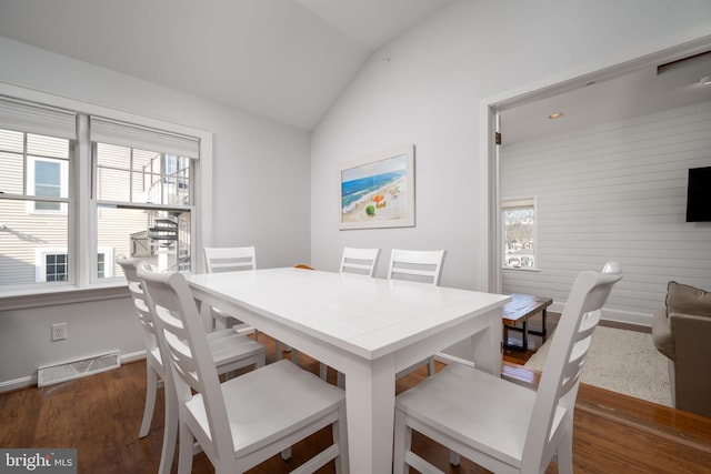 dining area with vaulted ceiling, plenty of natural light, and dark wood-type flooring