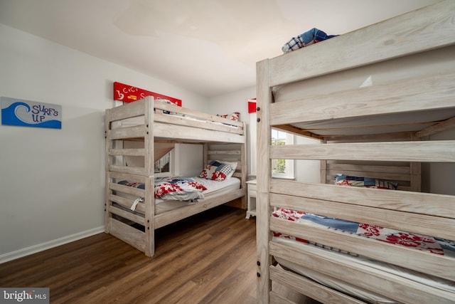 bedroom with dark wood-type flooring