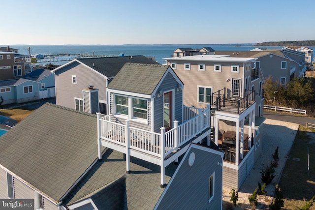 back of property featuring a water view