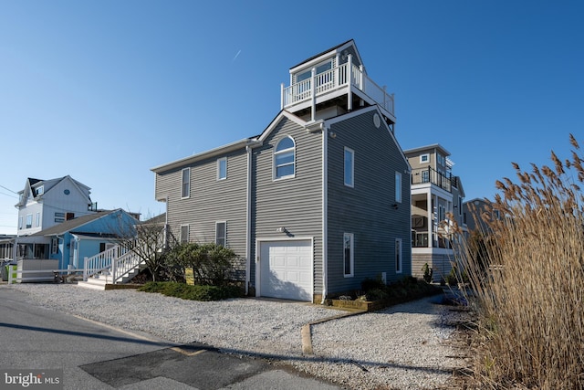 view of property exterior featuring a balcony and a garage