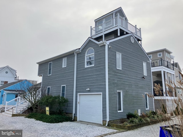 view of property exterior featuring a balcony and a garage