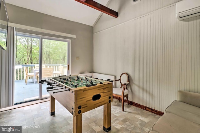 game room featuring lofted ceiling with beams and a wall mounted AC