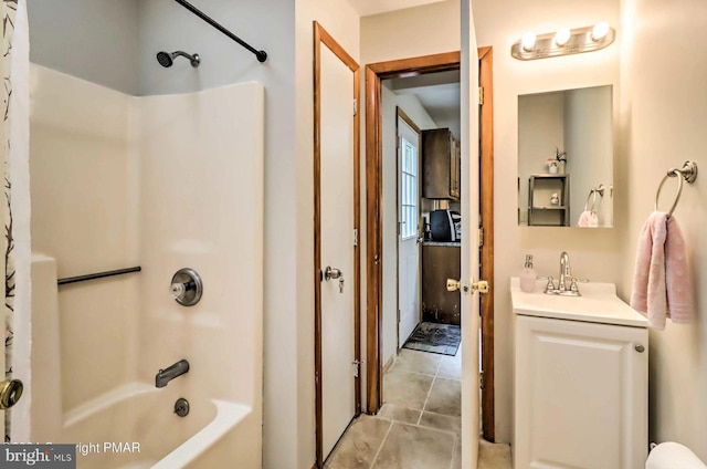 bathroom featuring tile patterned floors, vanity, and bathing tub / shower combination