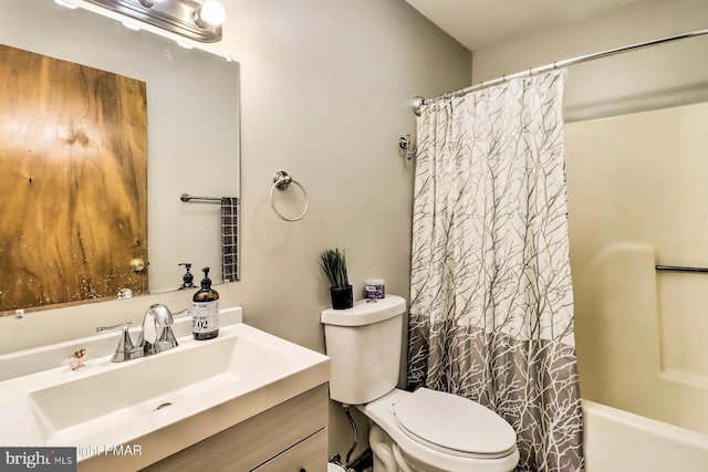 full bathroom featuring shower / bath combination with curtain, vanity, and toilet