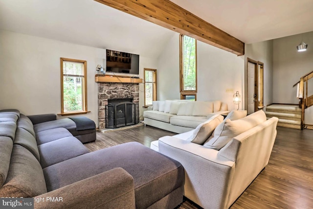 living room with a fireplace, vaulted ceiling with beams, and dark hardwood / wood-style flooring