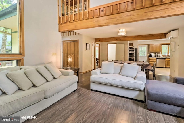 living room with an AC wall unit, dark hardwood / wood-style flooring, and beamed ceiling