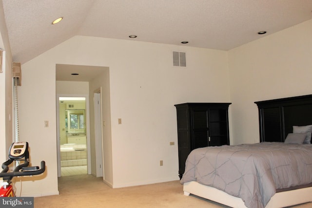 bedroom featuring ensuite bath, lofted ceiling, light carpet, and a textured ceiling