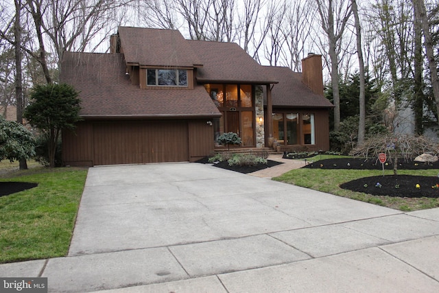 view of front of property with a garage and a front yard