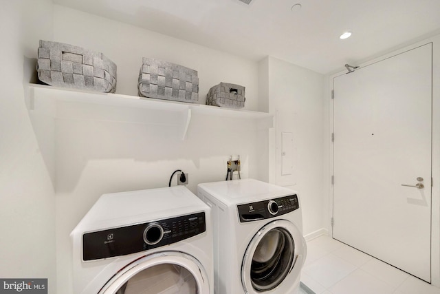 laundry area featuring independent washer and dryer and light tile patterned floors